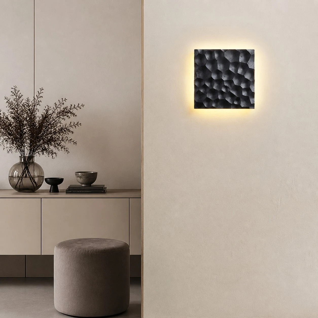 Ivory carved travertine wall sconce installed on a neutral wall