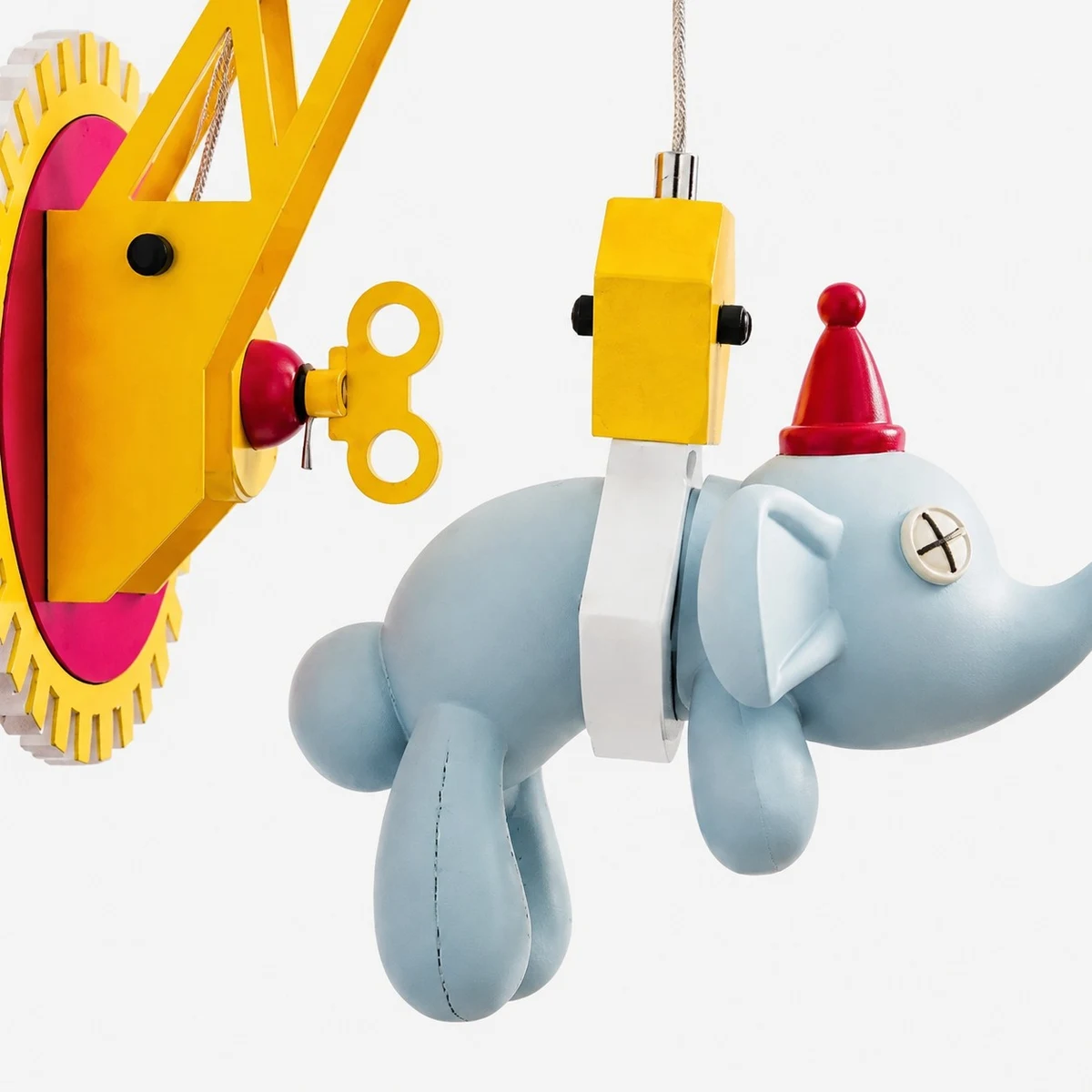 Close-up of blue elephant pendant and LED block