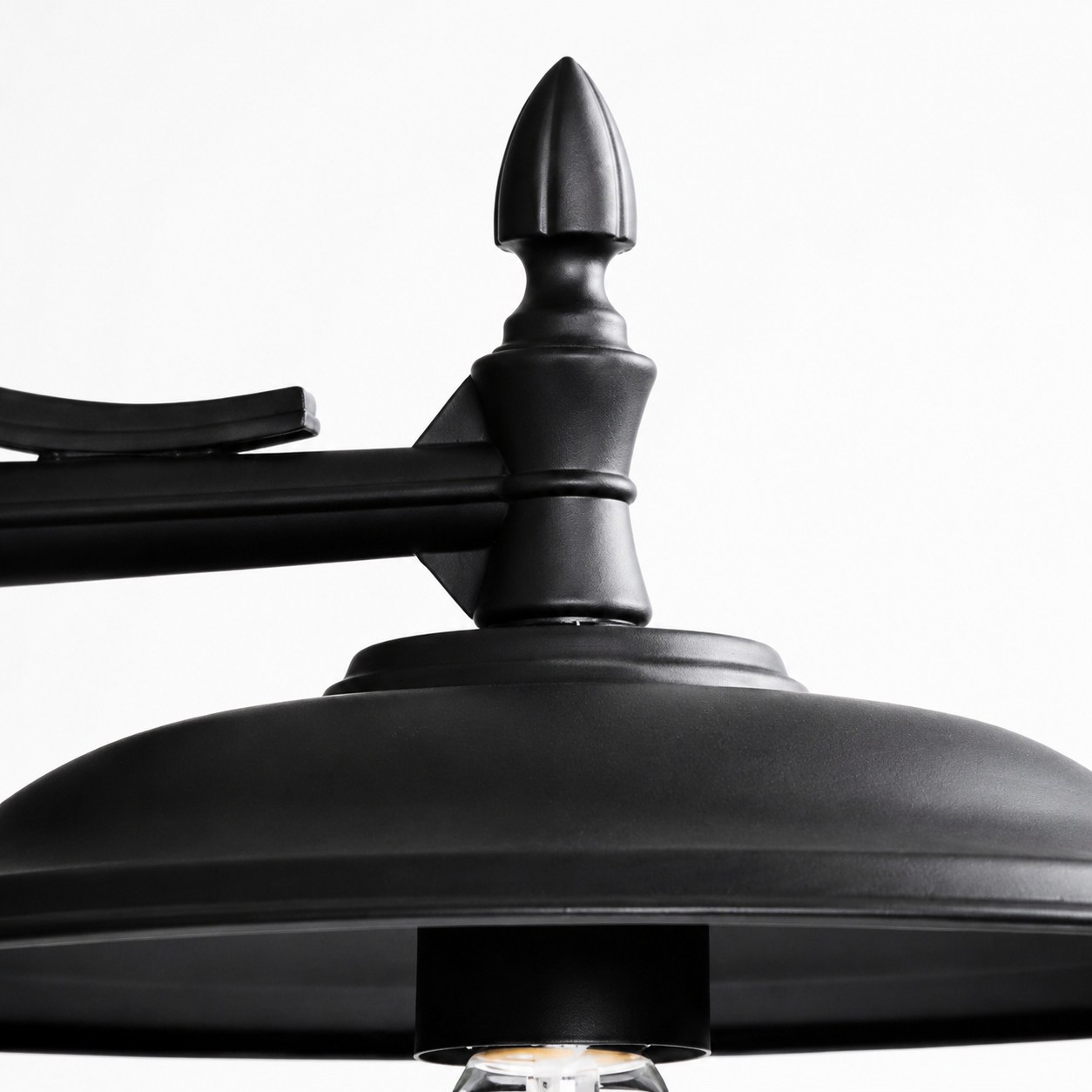 Close-up of the wide metal barn shade on the outdoor wall sconce