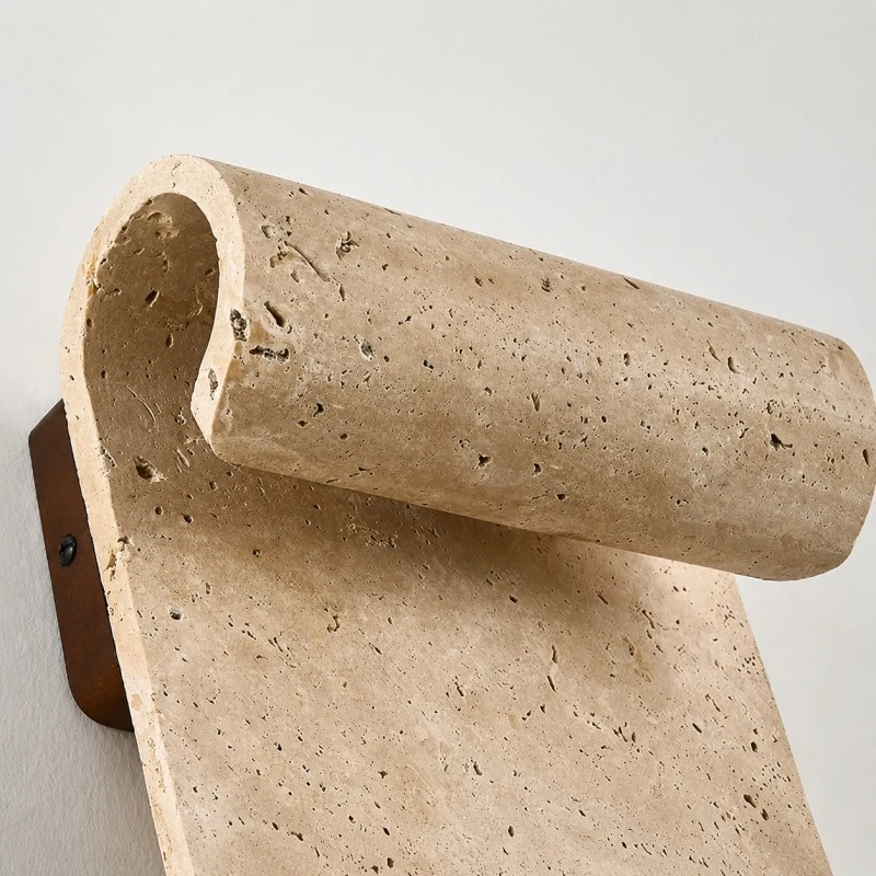 Side profile of natural travertine wall sconce