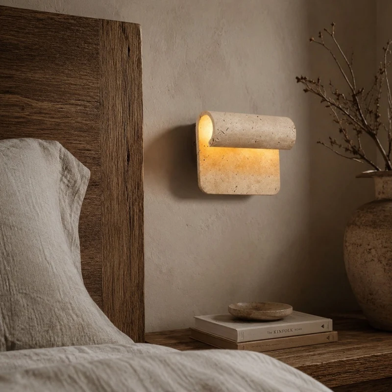 Travertine wall light near headboard