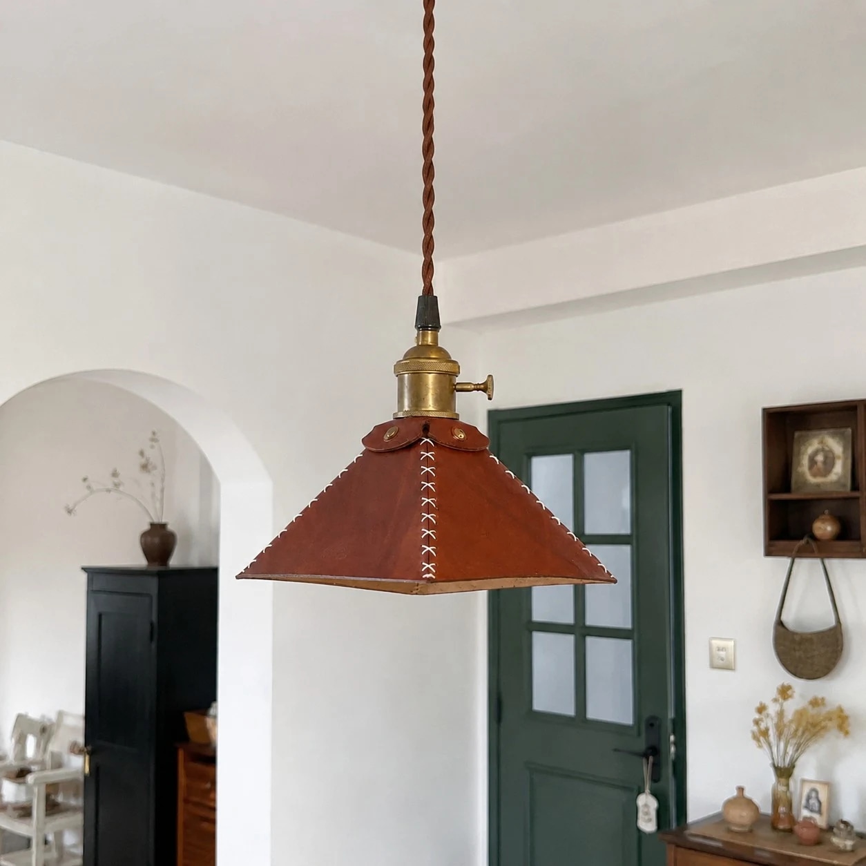 Leather pyramid pendant lamp in an arched room setting