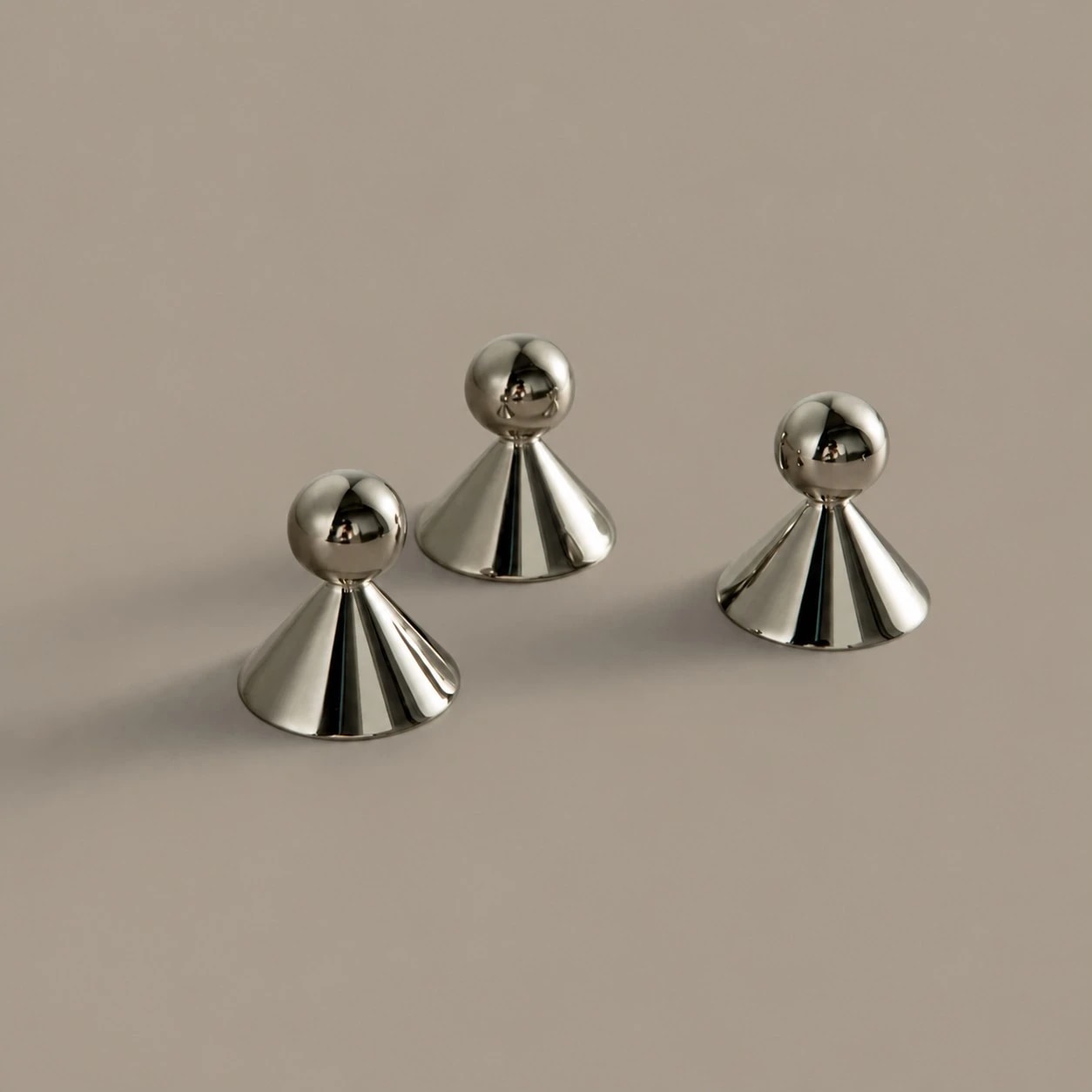 Sculptural brass cabinet knobs shown from several angles