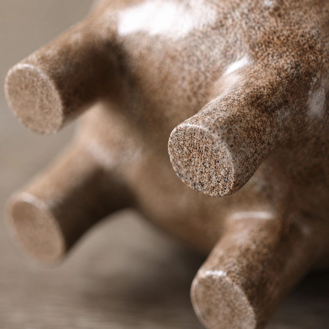 Close view of the rounded feet and speckled resin finish