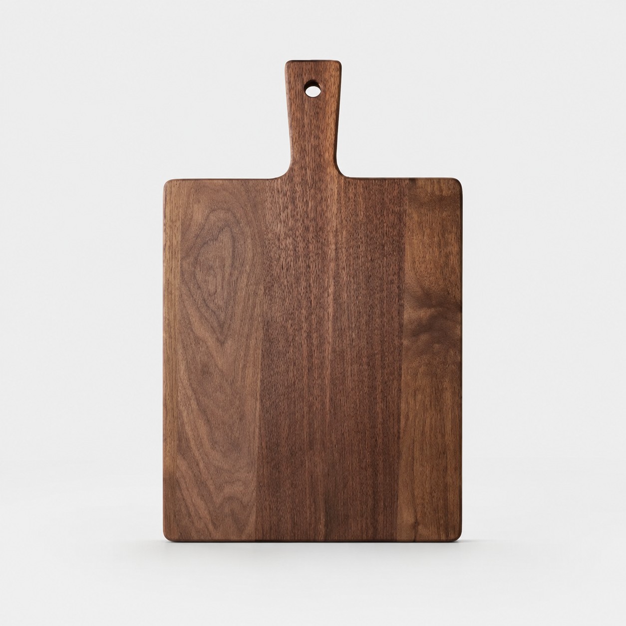 Large black walnut cutting board on a light background