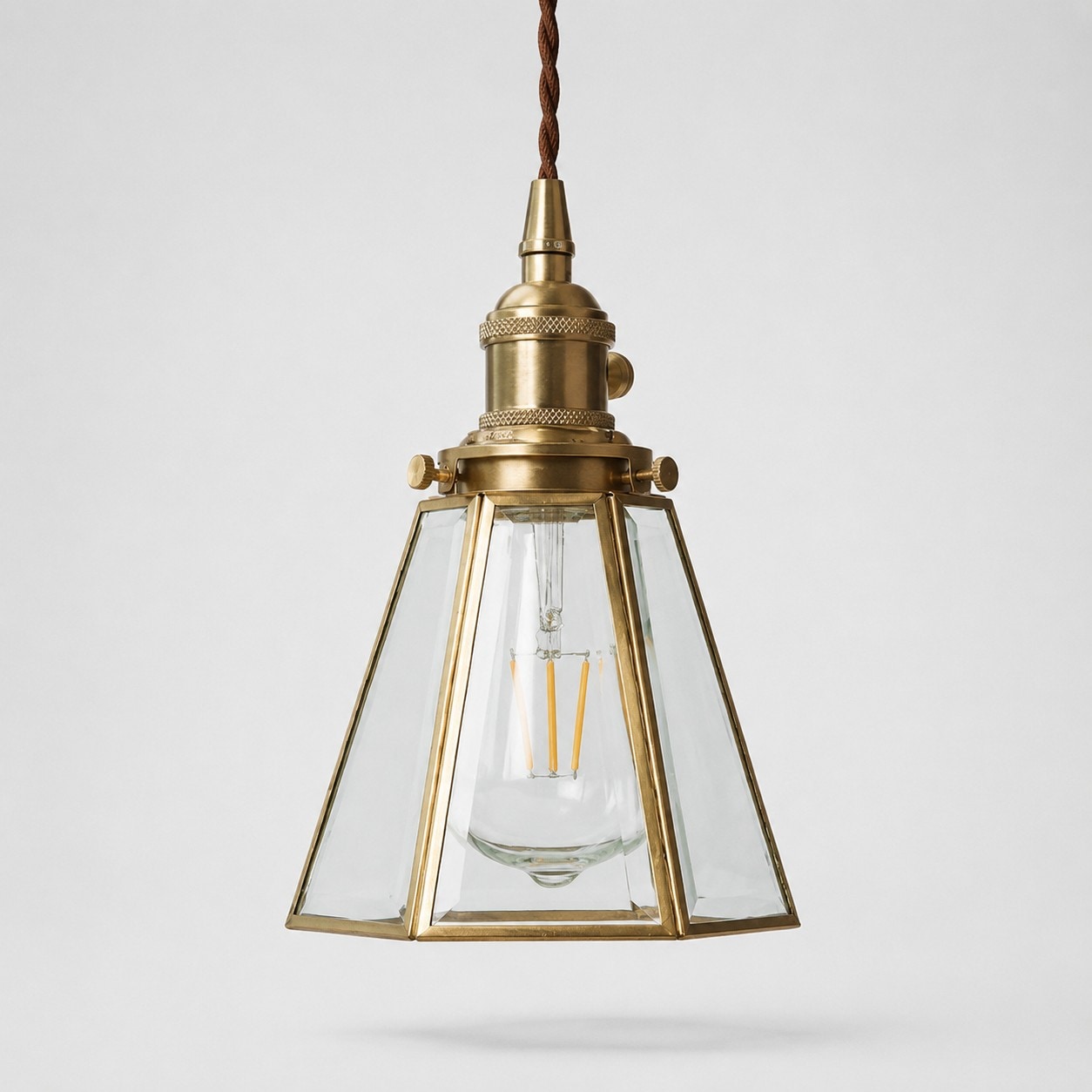 Clear glass pendant light with brass canopy