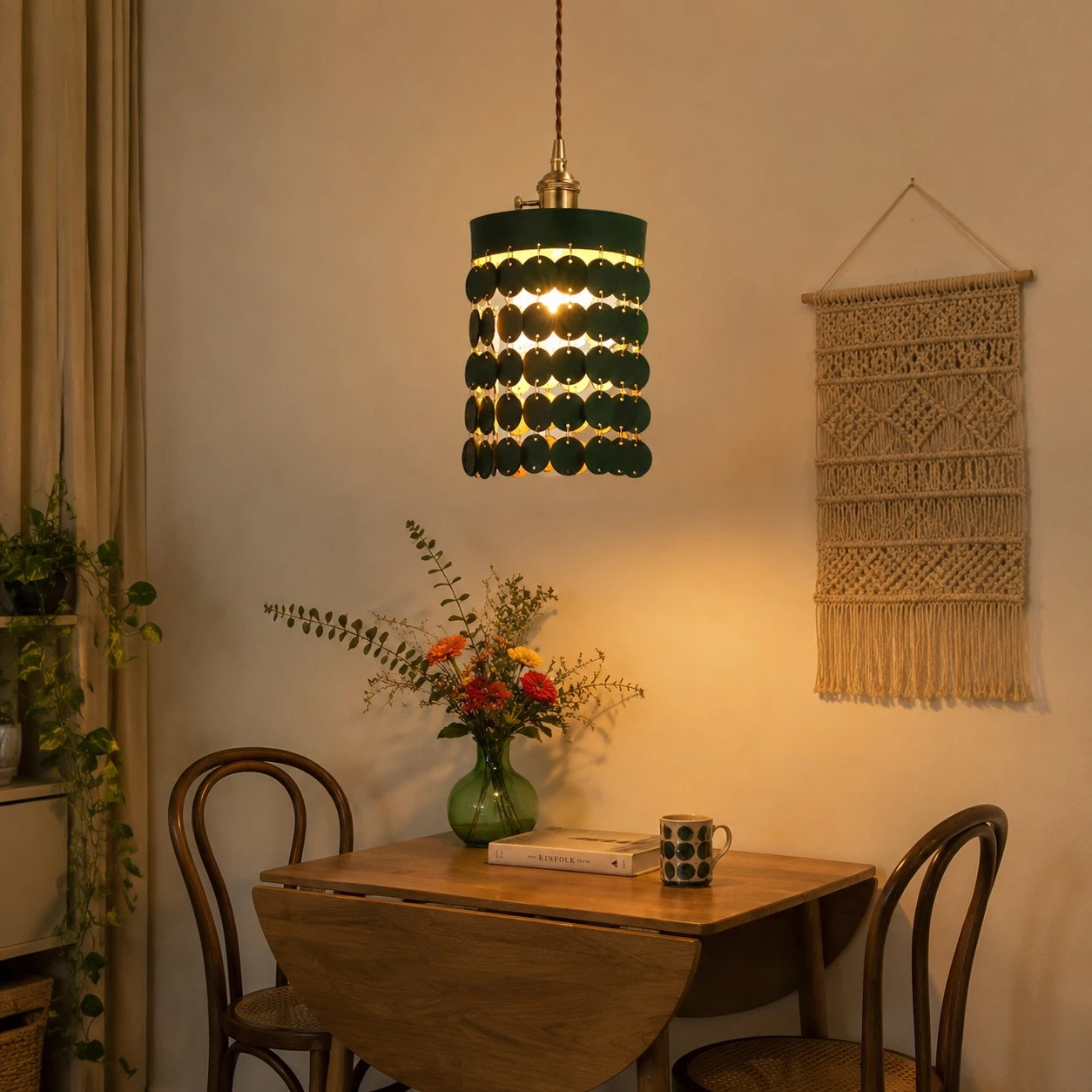 Green leather pendant light above a small dining table